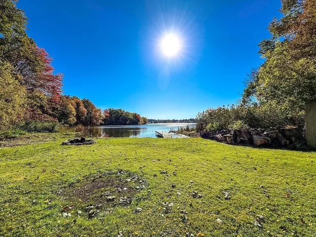 a view of a green field with sitting area