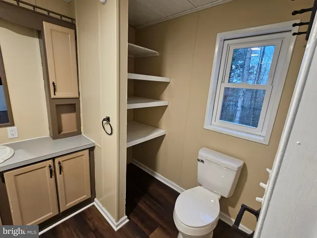 a white toilet sitting next to a bathroom sink