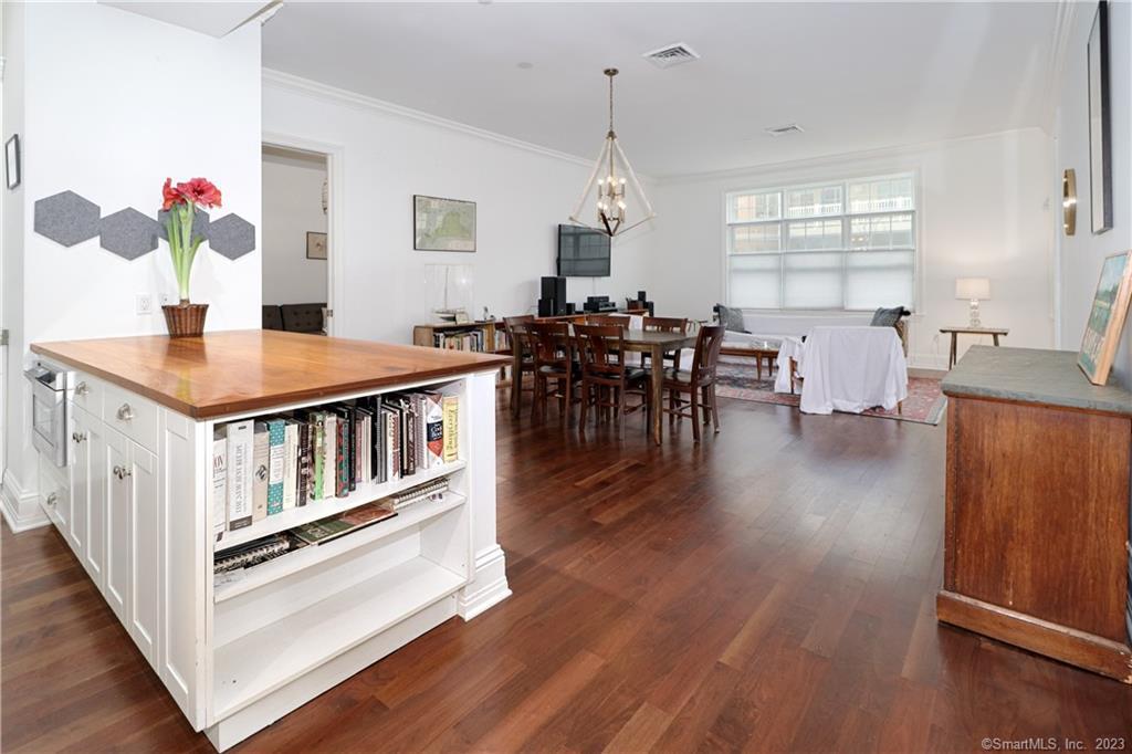 an open kitchen with dining room and wooden floor