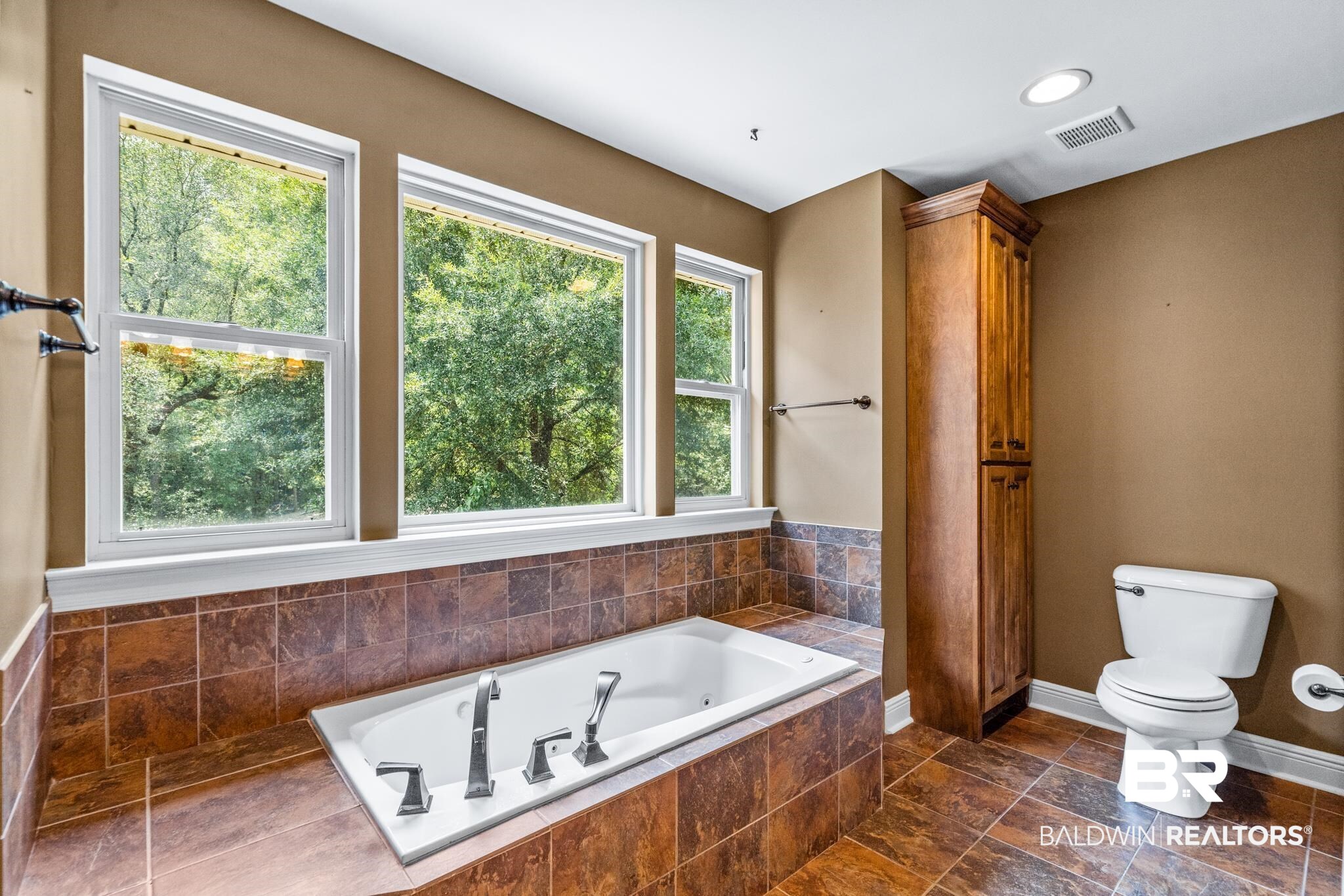 8321 Dixon Road Bay Minette, AL 36507 - Photo 51 of 79 Bathroom featuring a relaxing tiled tub, toilet, and tile patterned floors