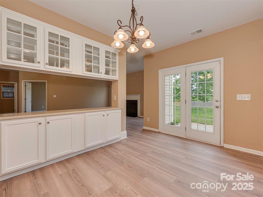 5607 Fulton Ridge Drive Indian Trail, NC 28079 - Photo 19 of 45 a view of an empty room with wooden floor and a window
