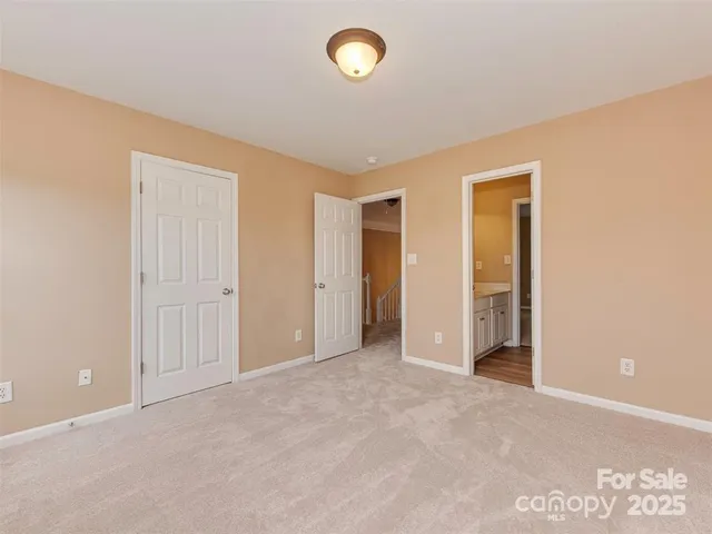 an empty room with fan and windows