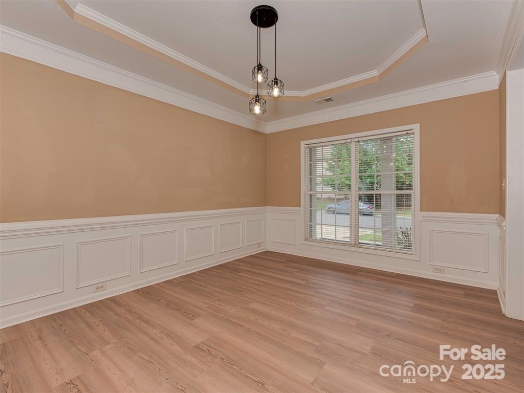 5607 Fulton Ridge Drive Indian Trail, NC 28079 - Photo 3 of 45 a view of an empty room with wooden floor and a window