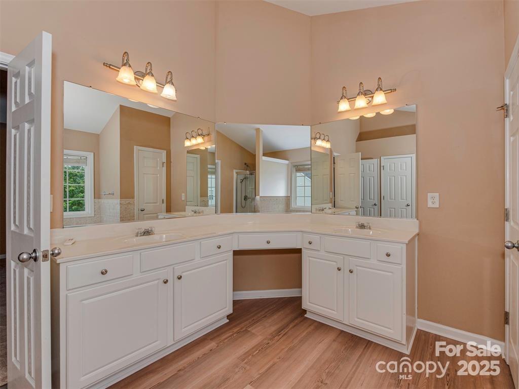 5607 Fulton Ridge Drive Indian Trail, NC 28079 - Photo 35 of 45 a spacious bathroom with a granite countertop sink a large mirror and a vanity