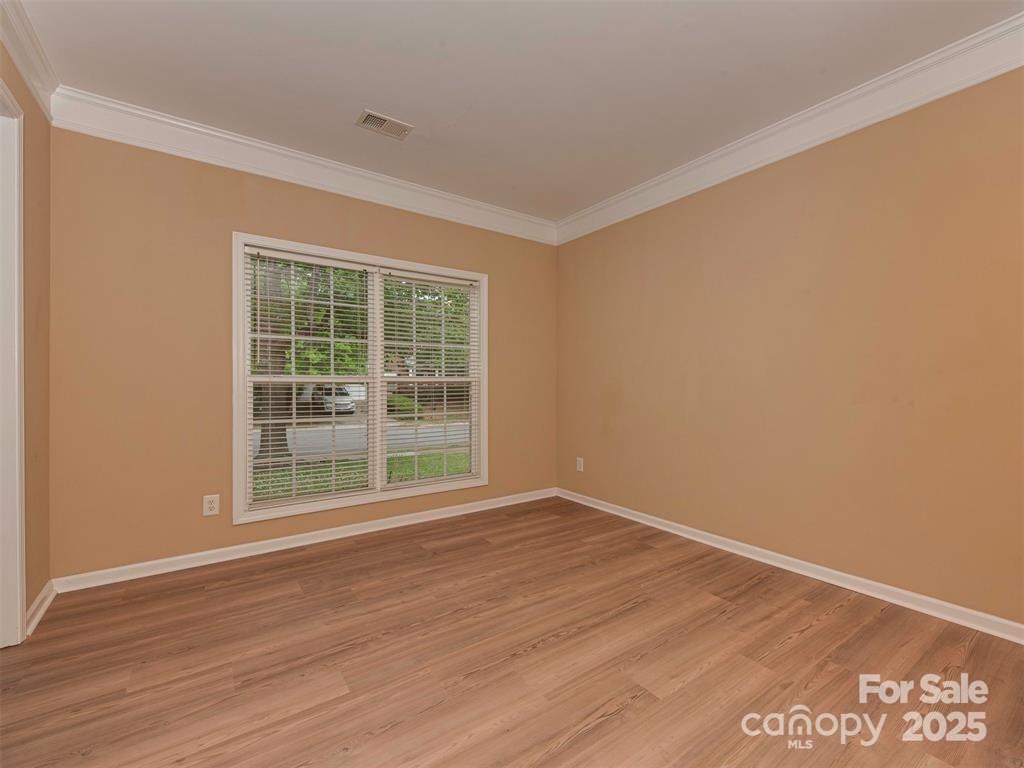 5607 Fulton Ridge Drive Indian Trail, NC 28079 - Photo 5 of 45 a view of an empty room with wooden floor and a window