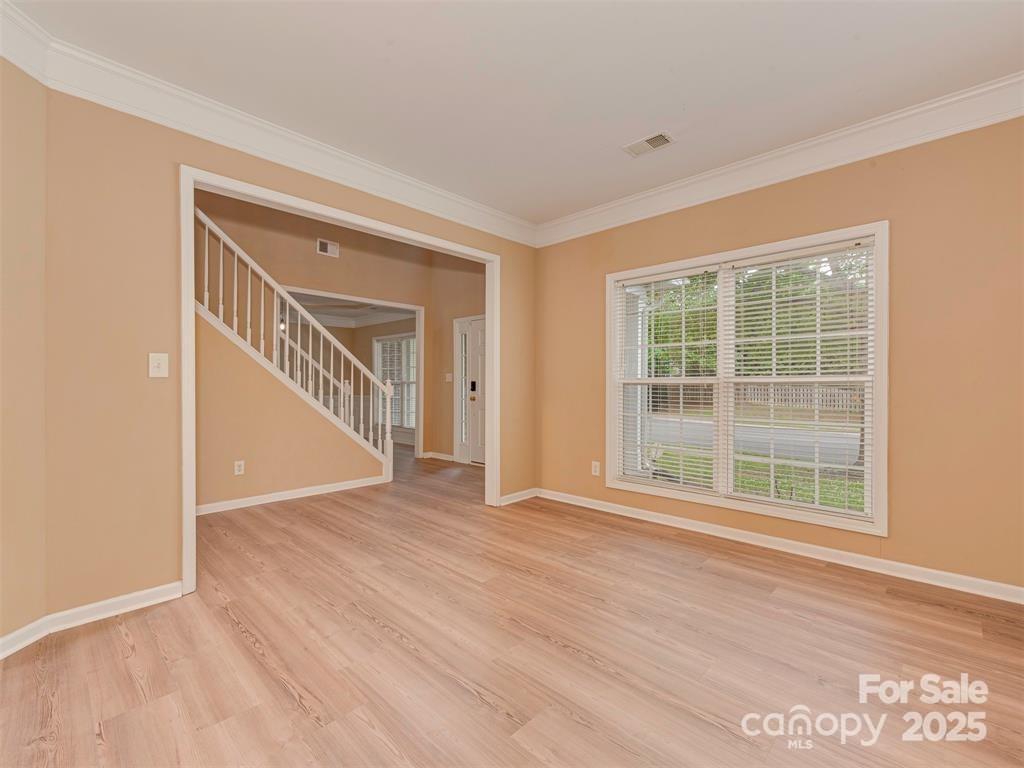 5607 Fulton Ridge Drive Indian Trail, NC 28079 - Photo 6 of 45 a view of an empty room with wooden floor and windows