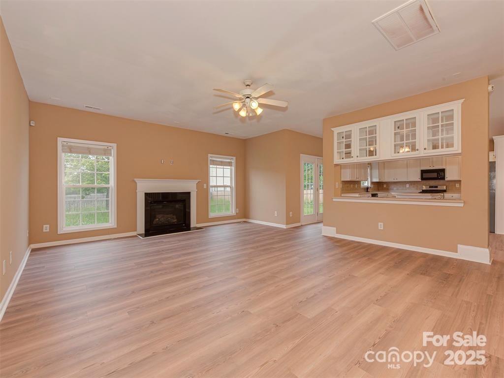 5607 Fulton Ridge Drive Indian Trail, NC 28079 - Photo 10 of 45 a view of an empty room with a fireplace and a window