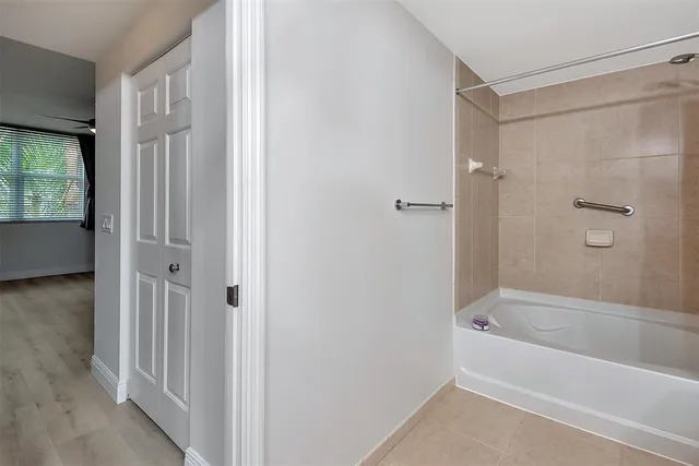 a bathroom with a toilet a sink a mirror a vanity and shower