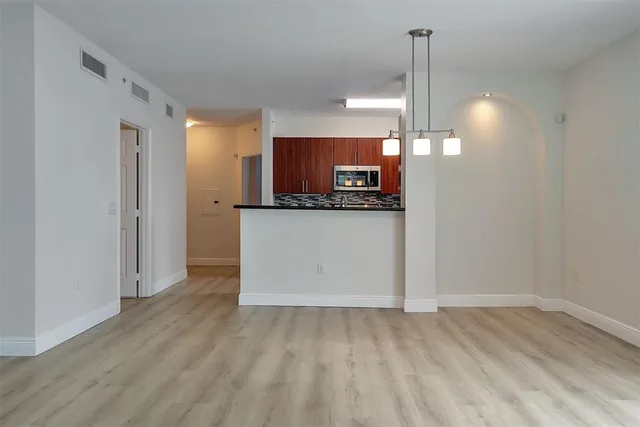 a kitchen with granite countertop a sink and stove top oven