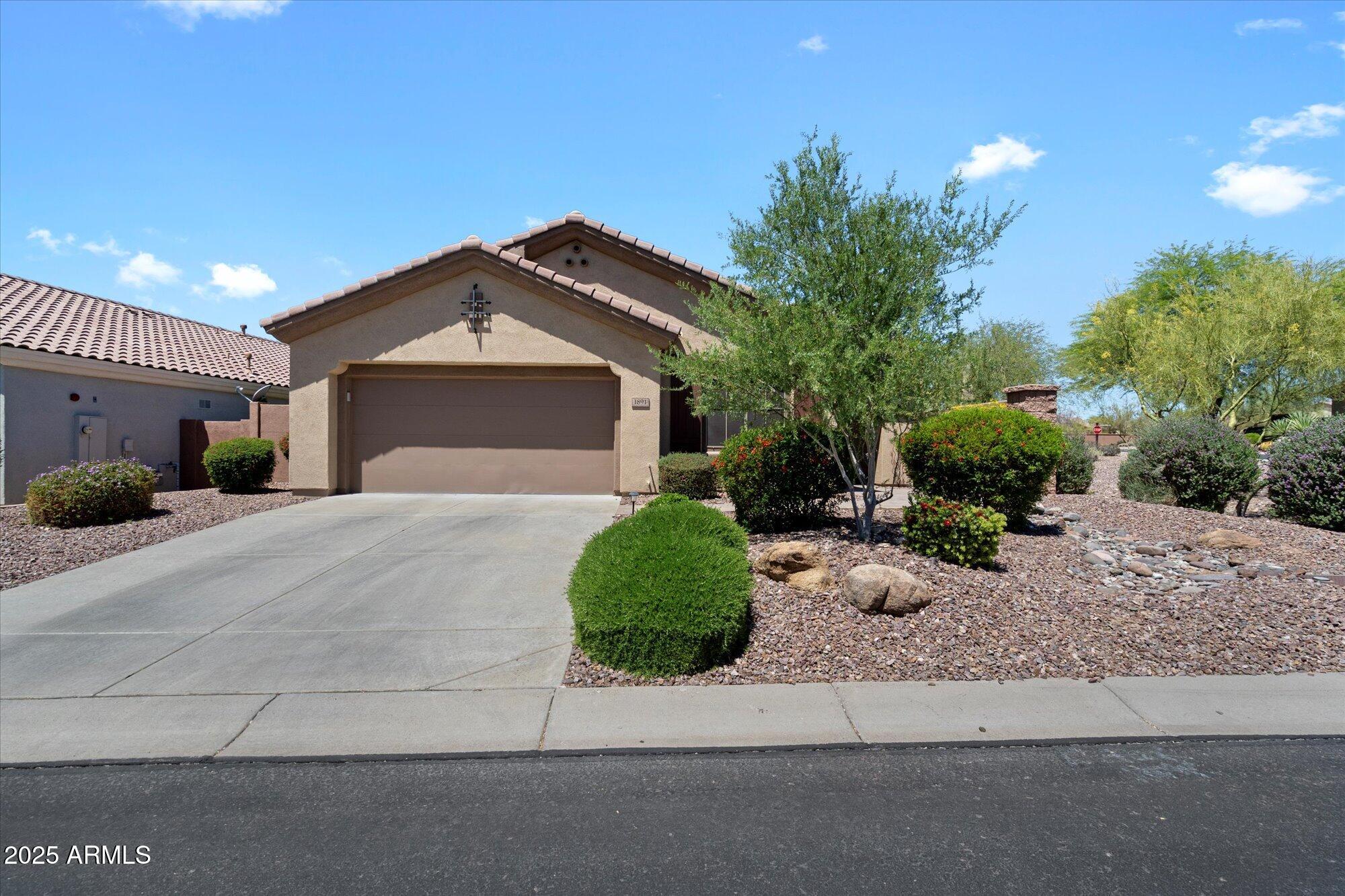 a front view of a house with a yard and a garage