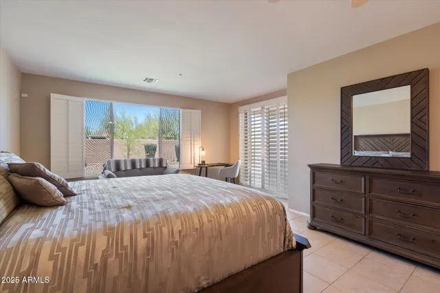 a bedroom with a large bed and a window