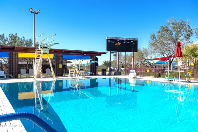 a view of a swimming pool with a table and chairs