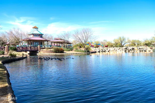 a view of a lake with boats and trees in the background