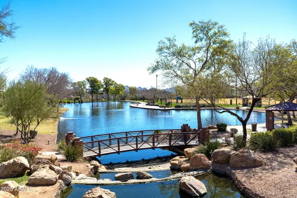 a view of a lake with couches and a patio