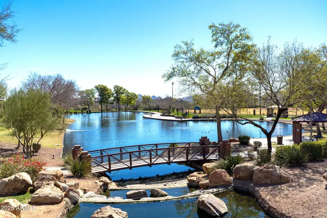 a view of a lake with couches and a patio
