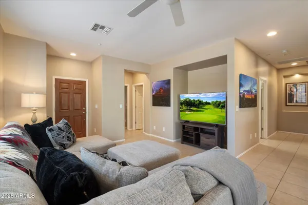 a bedroom with furniture and a flat screen tv