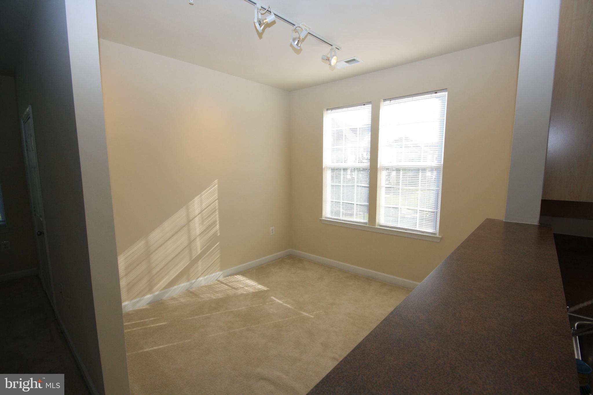 22691 Blue Elder Terrace, Unit 204 Brambleton, VA 20148 - Photo 11 of 45 a view of an empty room with a window