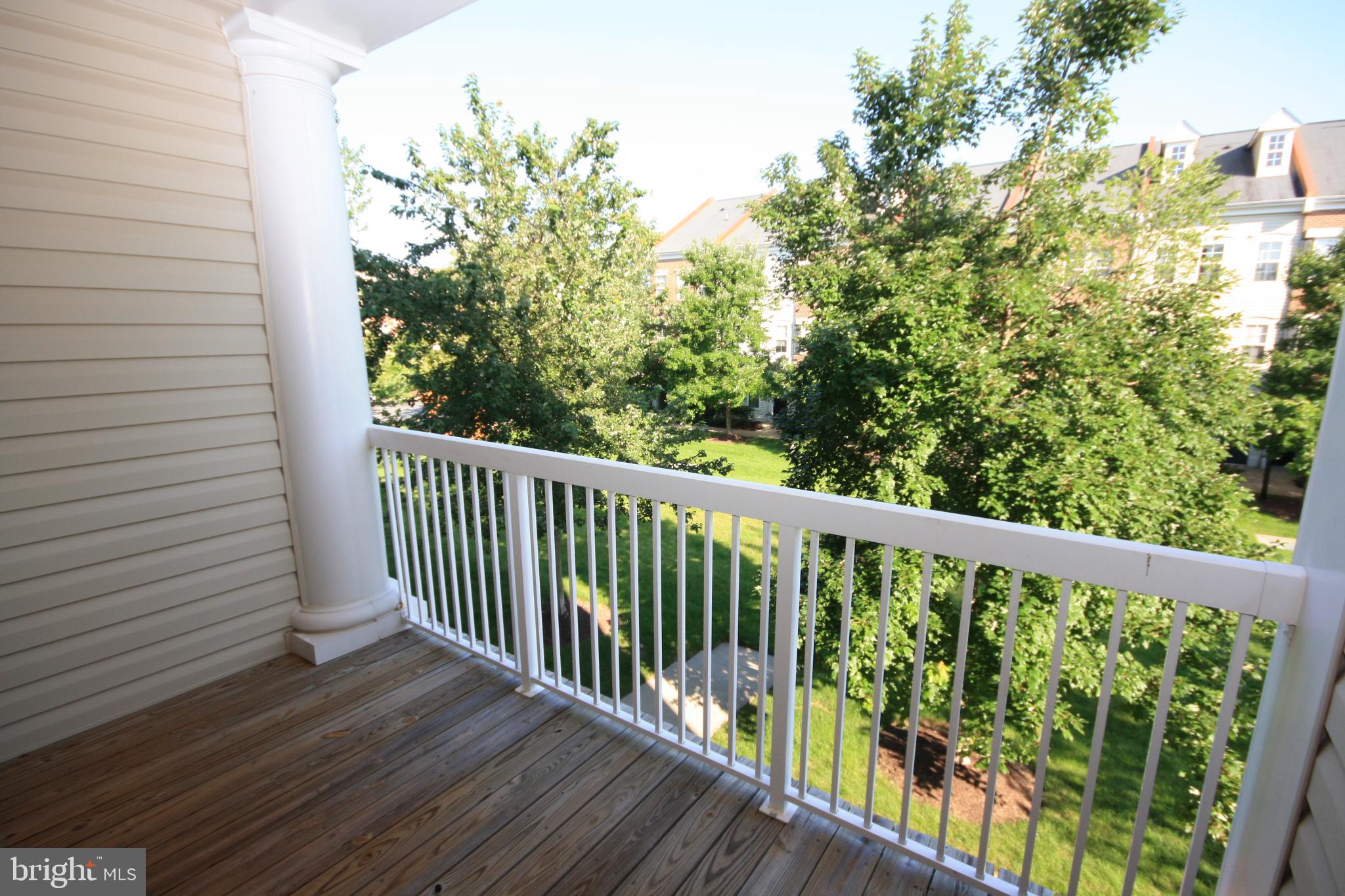 22691 Blue Elder Terrace, Unit 204 Brambleton, VA 20148 - Photo 17 of 45 a view of a balcony with wooden floor