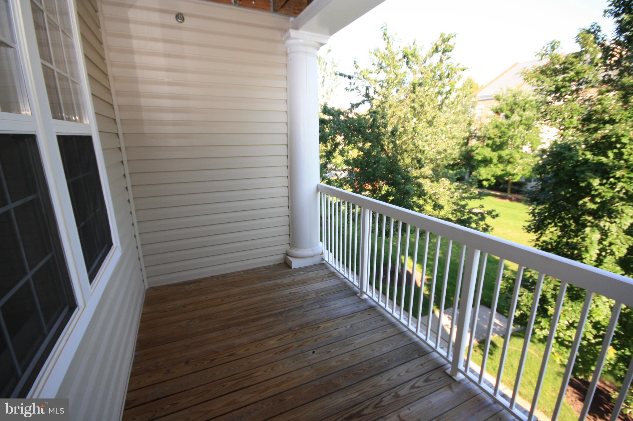 22691 Blue Elder Terrace, Unit 204 Brambleton, VA 20148 - Photo 20 of 45 a view of a balcony with wooden floor