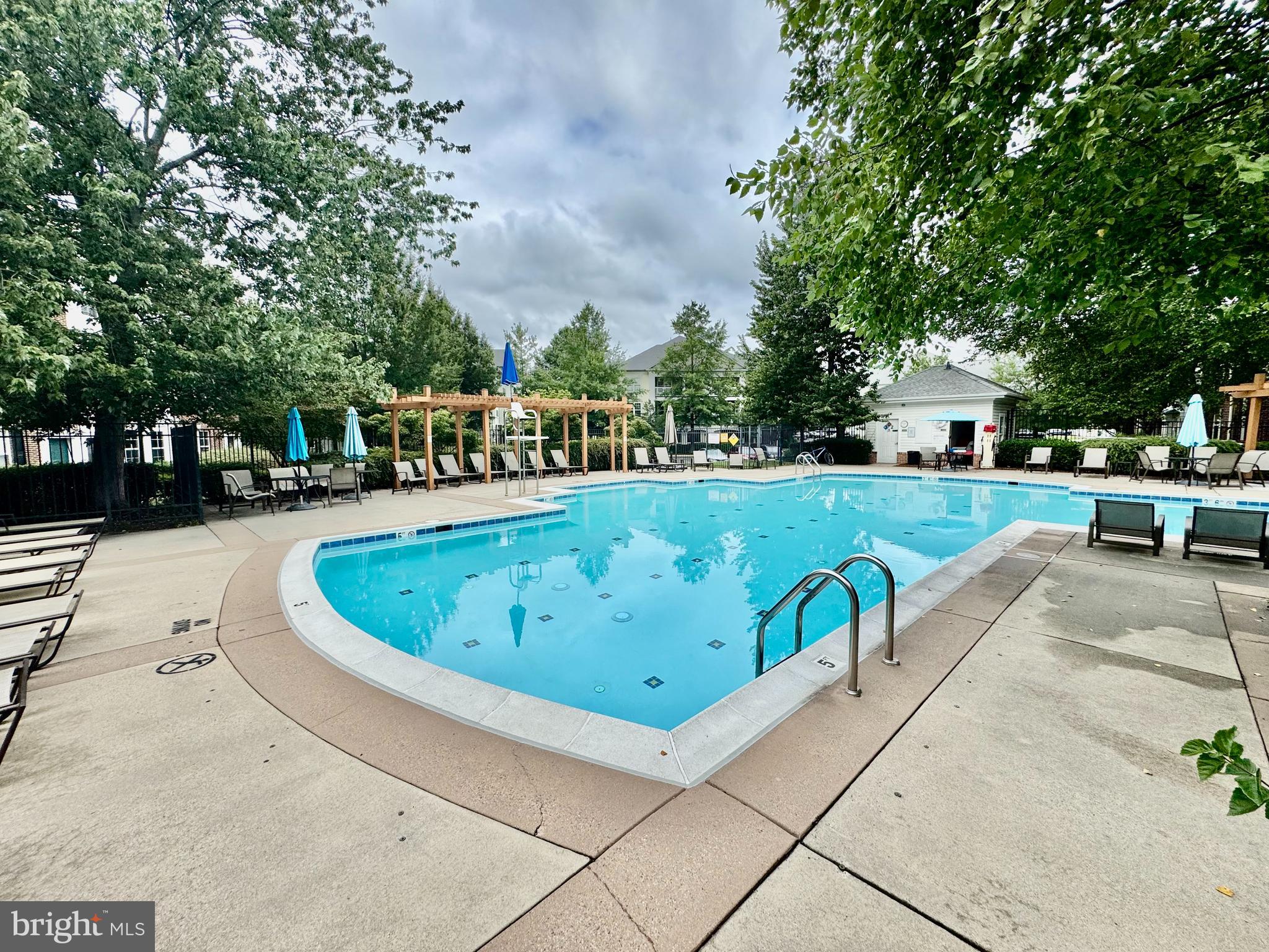 22691 Blue Elder Terrace, Unit 204 Brambleton, VA 20148 - Photo 31 of 45 a view of a swimming pool with chairs