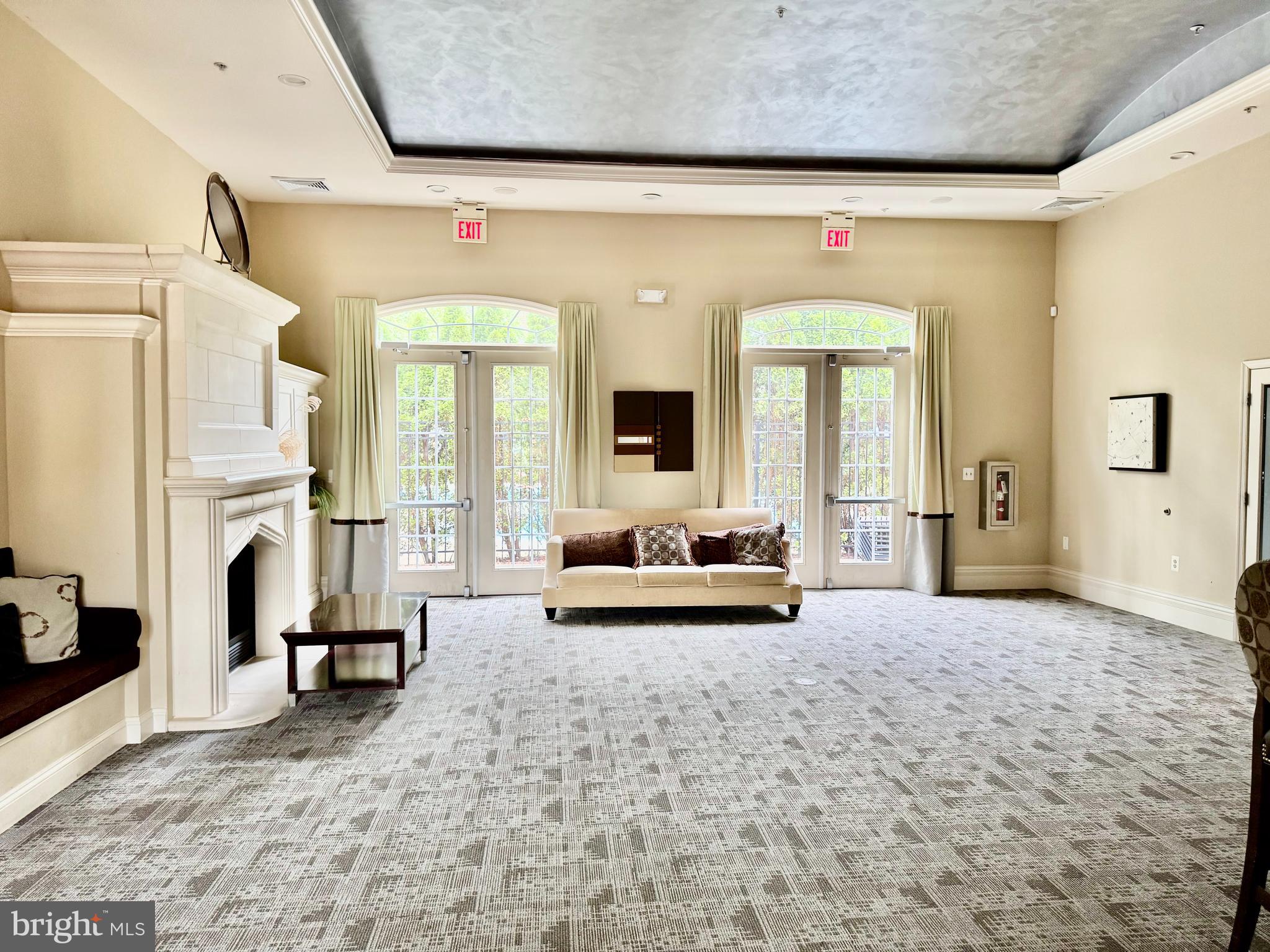 22691 Blue Elder Terrace, Unit 204 Brambleton, VA 20148 - Photo 40 of 45 a living room with furniture and a fireplace