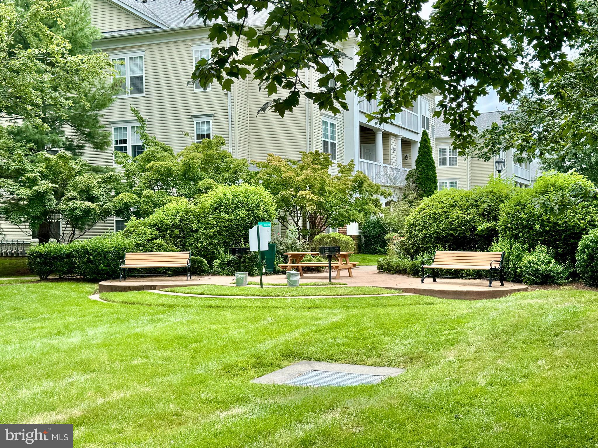 22691 Blue Elder Terrace, Unit 204 Brambleton, VA 20148 - Photo 42 of 45 a view of a house with a yard and sitting area
