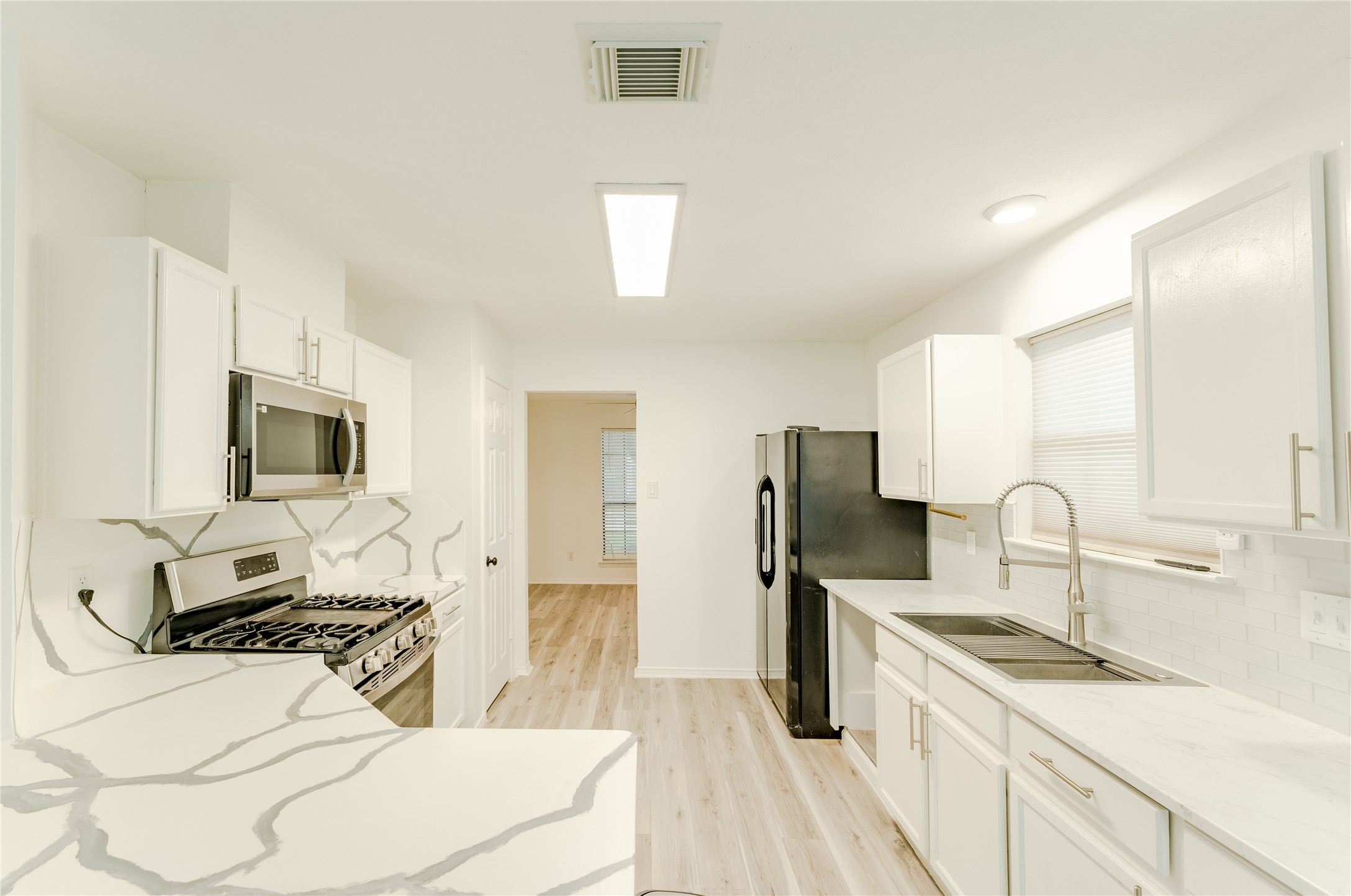 9203 Appin Court Houston, TX 77095 - Photo 1 of 38 a kitchen with a stove a sink and a refrigerator