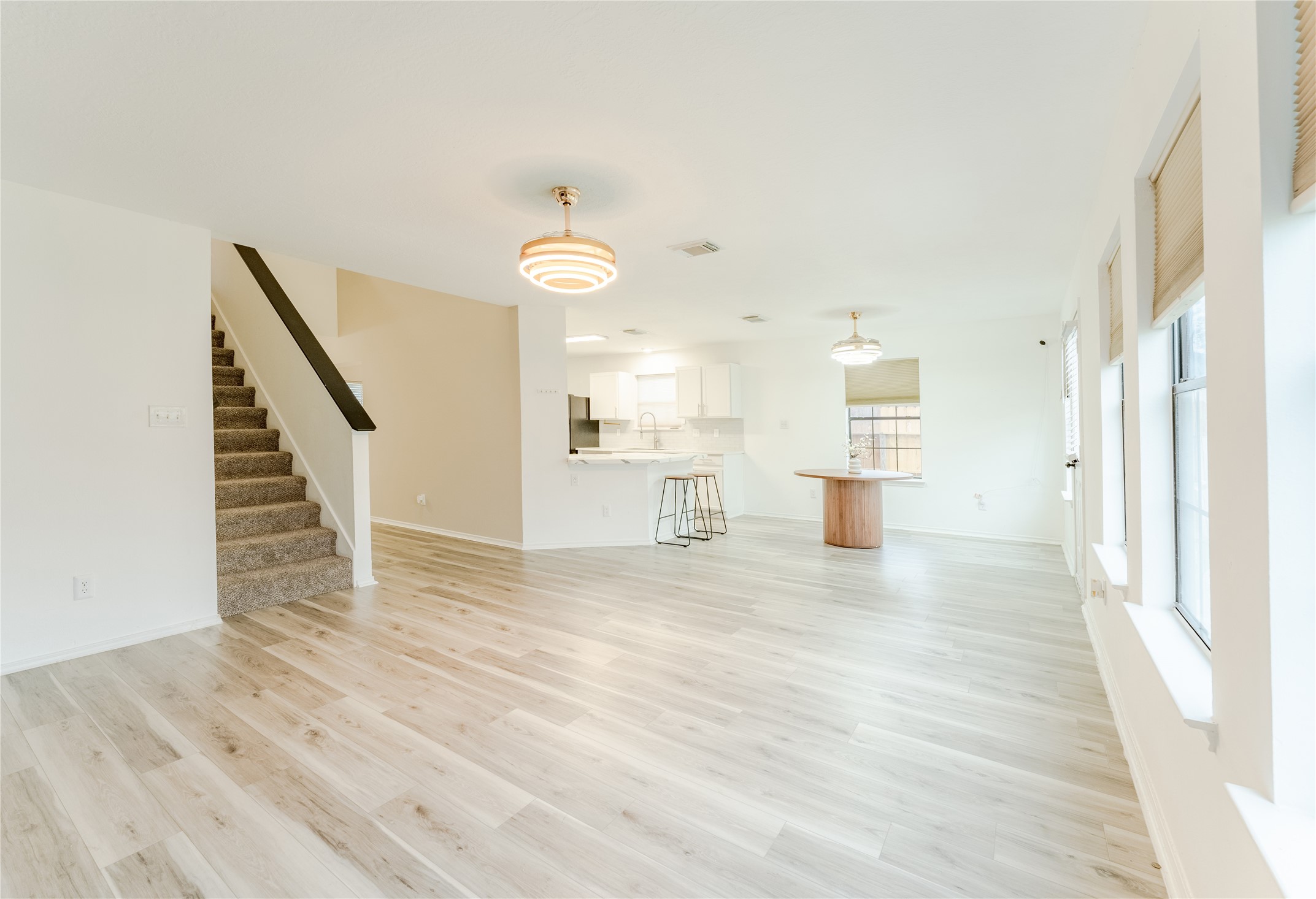 9203 Appin Court Houston, TX 77095 - Photo 11 of 38 a view of empty room with wooden floor and kitchen