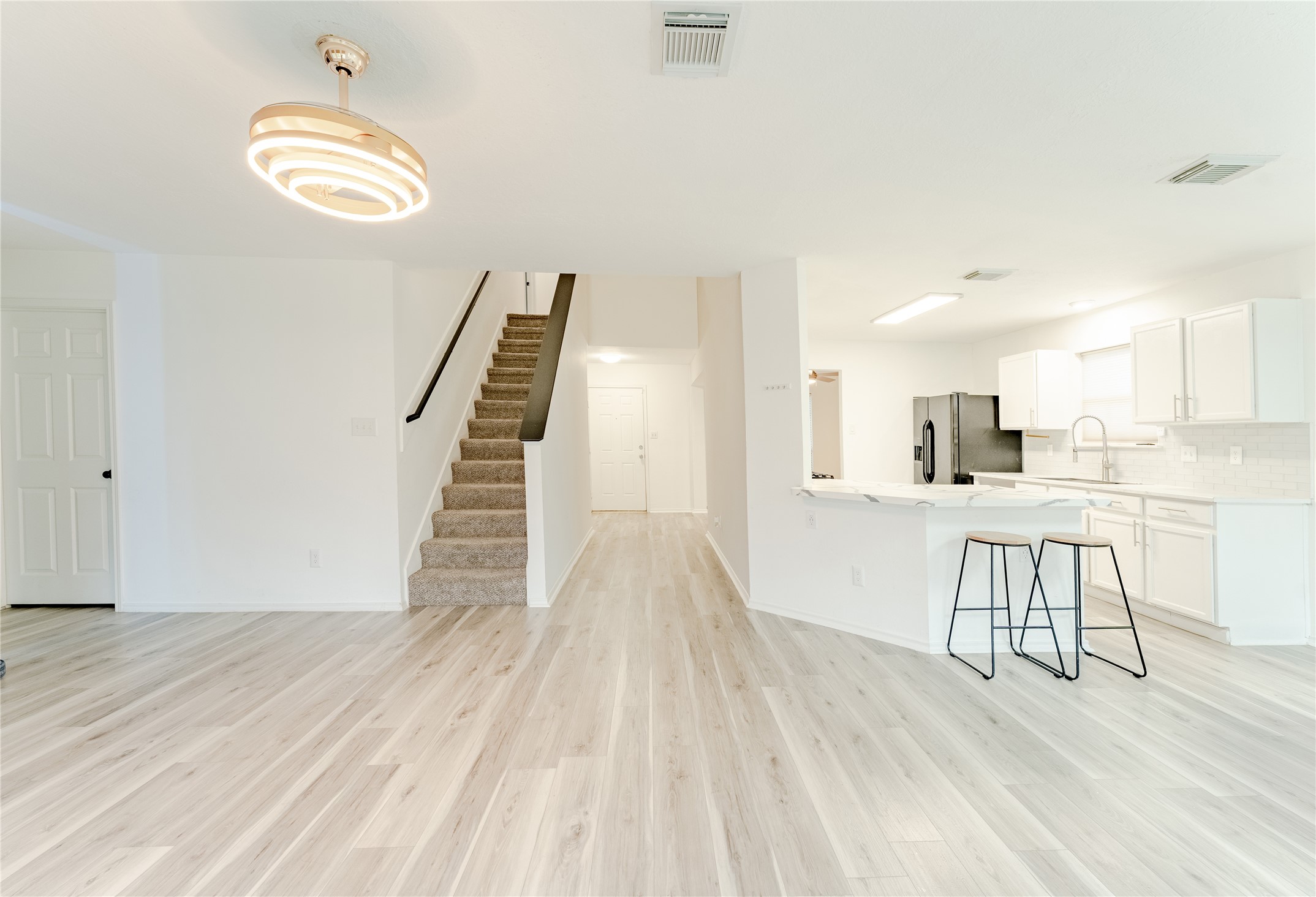 9203 Appin Court Houston, TX 77095 - Photo 12 of 38 a view of a kitchen with wooden floor and a view of living room