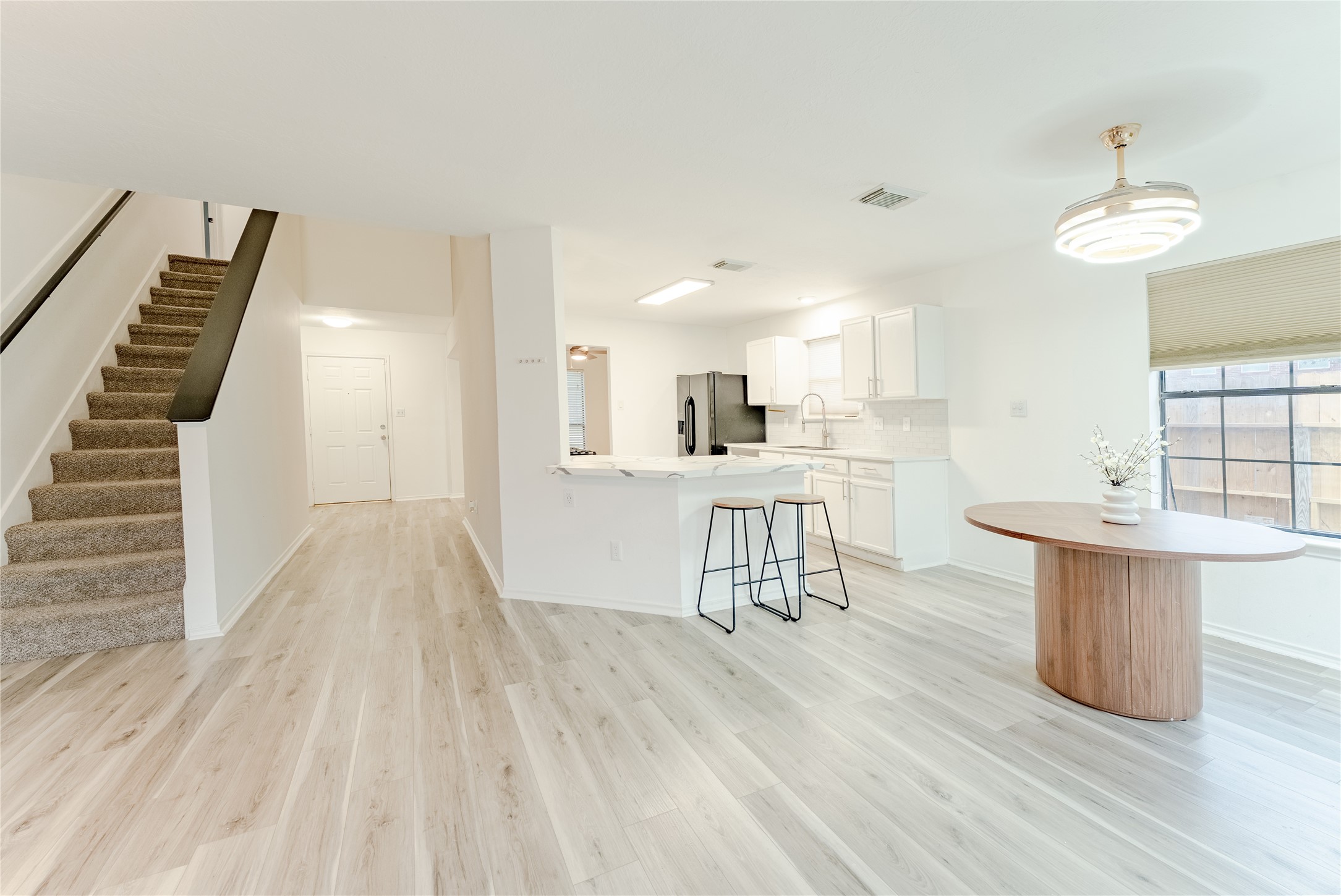 9203 Appin Court Houston, TX 77095 - Photo 13 of 38 a view of a kitchen with dining room and wooden floor