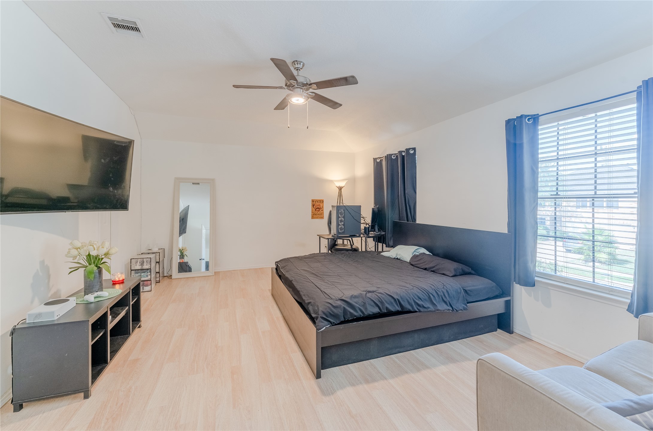 9203 Appin Court Houston, TX 77095 - Photo 17 of 38 a spacious bedroom with a bed window and flat screen tv