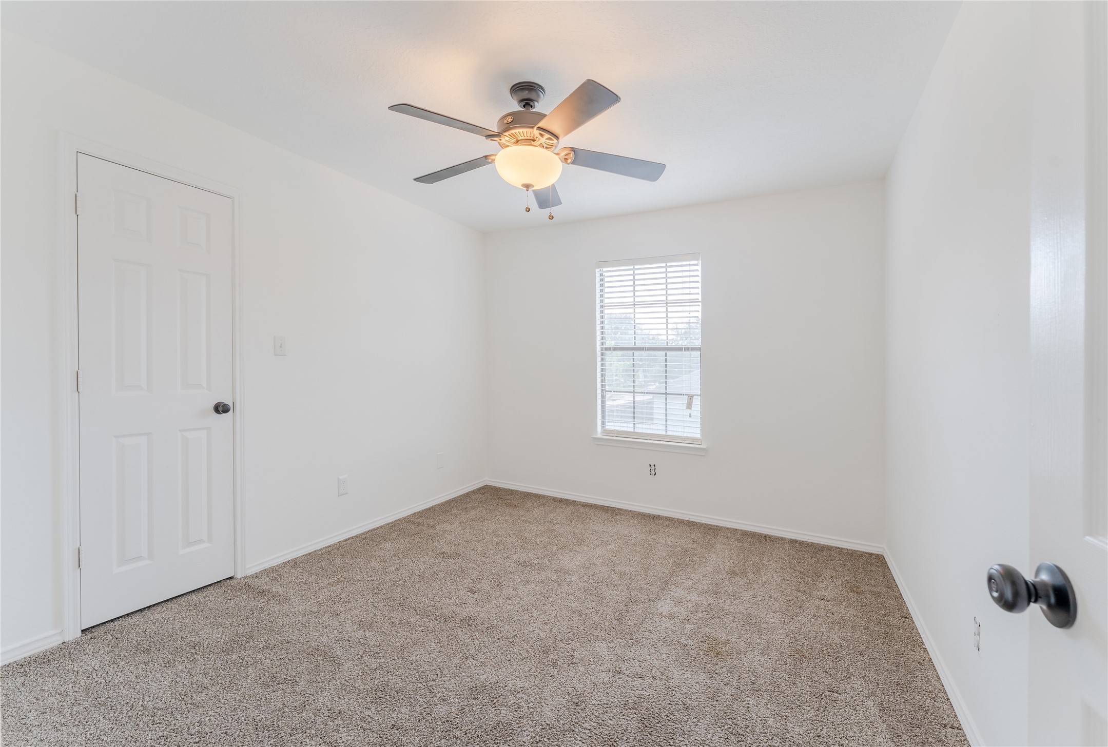 9203 Appin Court Houston, TX 77095 - Photo 27 of 38 an empty room with windows and fan