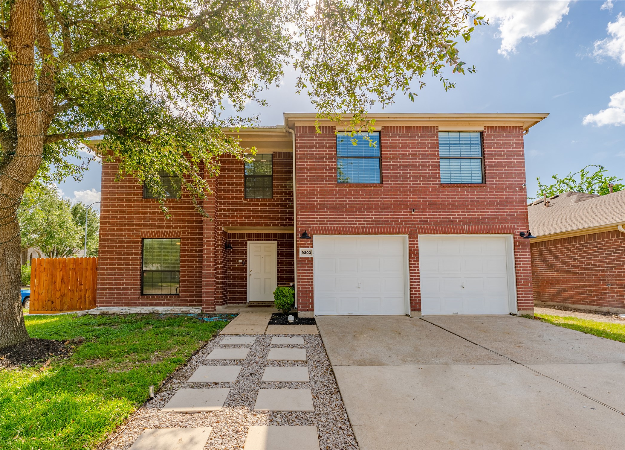 9203 Appin Court Houston, TX 77095 - Photo 8 of 38 a front view of a house with a yard and garage