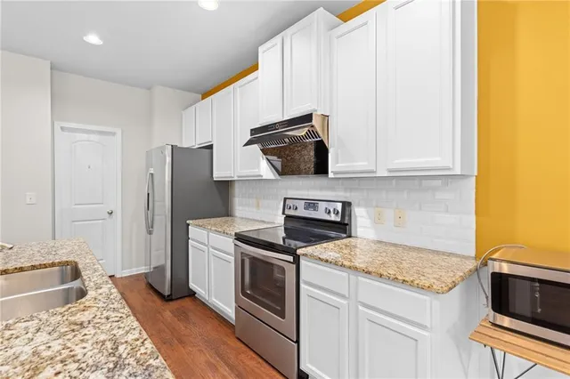 a kitchen with a stove and a refrigerator