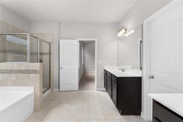 a view of bathroom with a tub sink shower and mirror