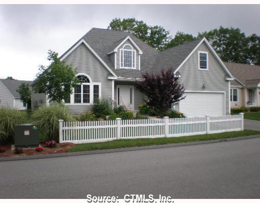 a front view of a house with a garden and plants