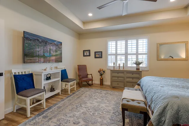 a bedroom with a bed and a painting on the wall