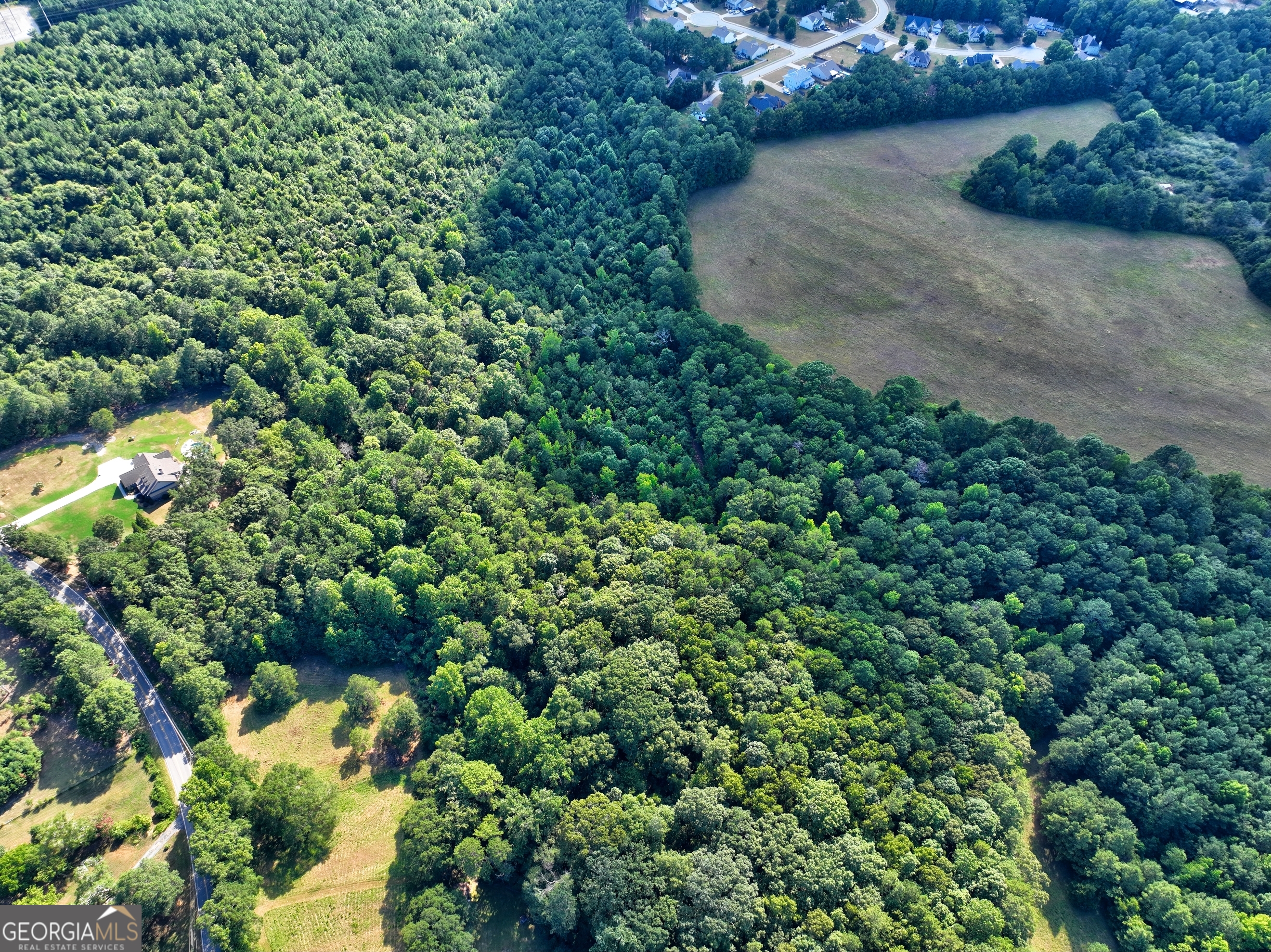 0 New Hope Church Road Loganville, GA 30052 - Photo 24 of 33 an aerial view of a house with a yard and swimming pool