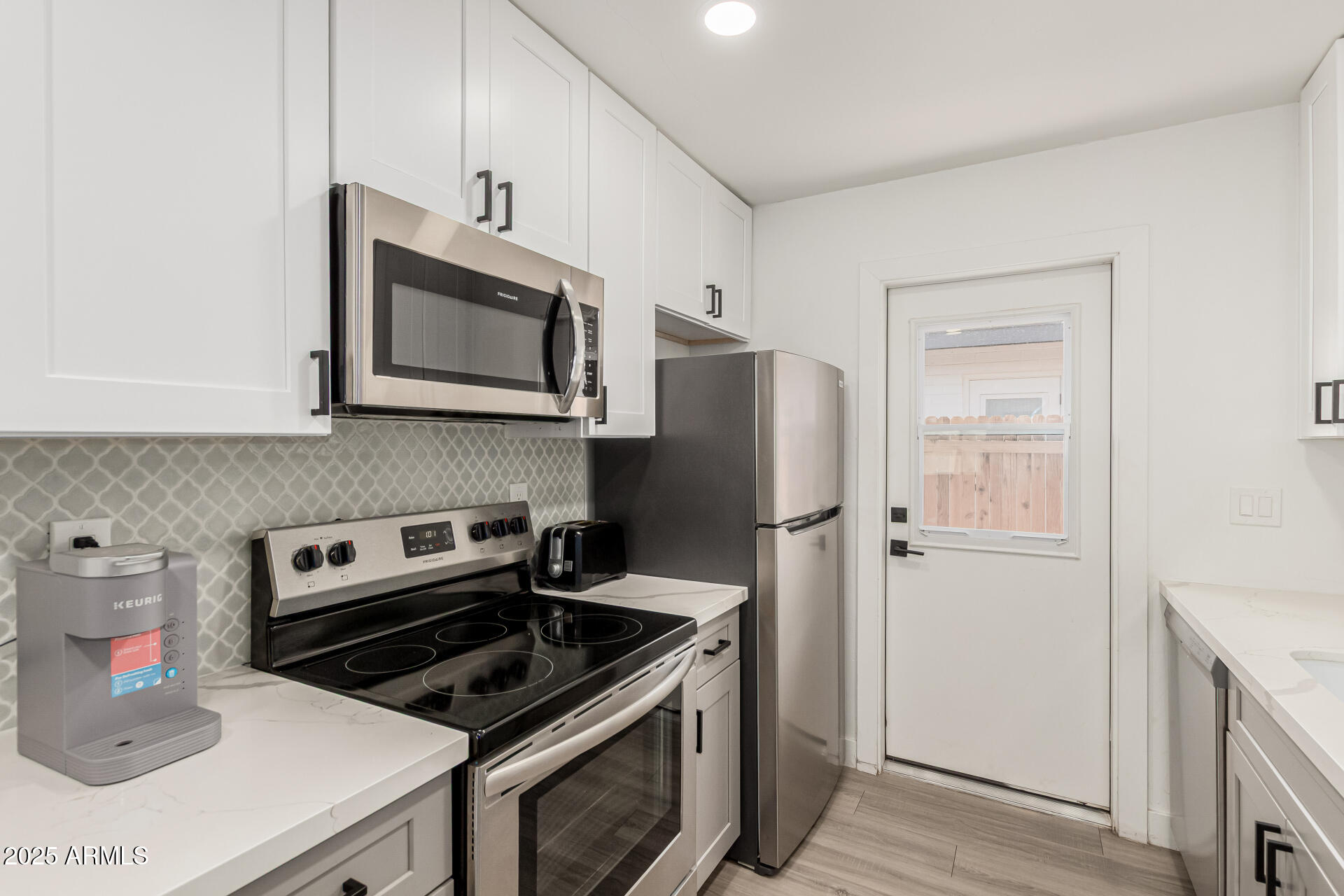 6628 East Avalon Drive, Unit 1 Scottsdale, AZ 85251 - Photo 12 of 29 a kitchen with a stove and a microwave