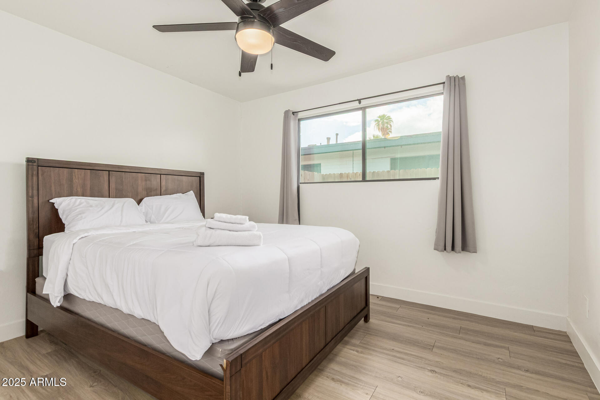 6628 East Avalon Drive, Unit 1 Scottsdale, AZ 85251 - Photo 15 of 29 a large bed sitting in a bedroom next to a window