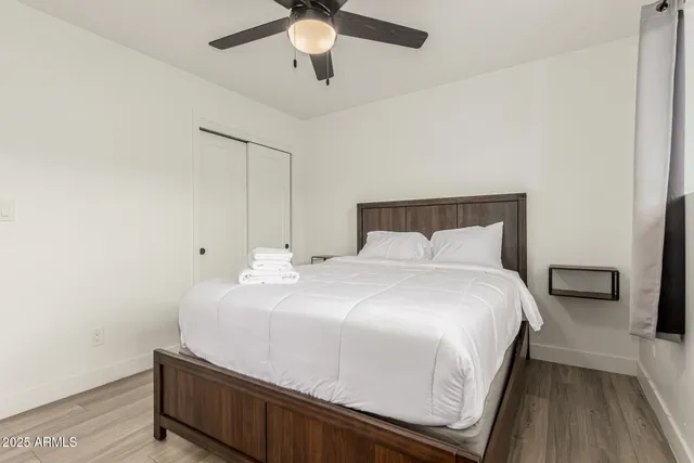 a bedroom with a bed and a chandelier