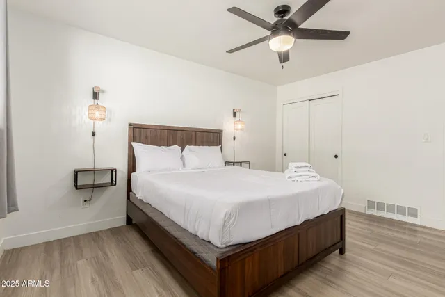 a bedroom with a bed and a ceiling fan