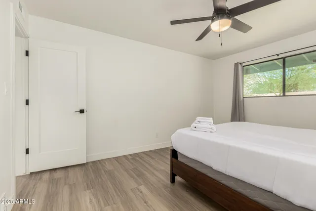 a room with a bed and a chandelier