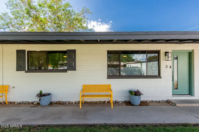 a backyard of a house with table and chairs