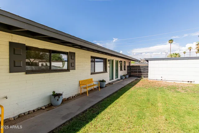 a swimming pool with outdoor seating and yard