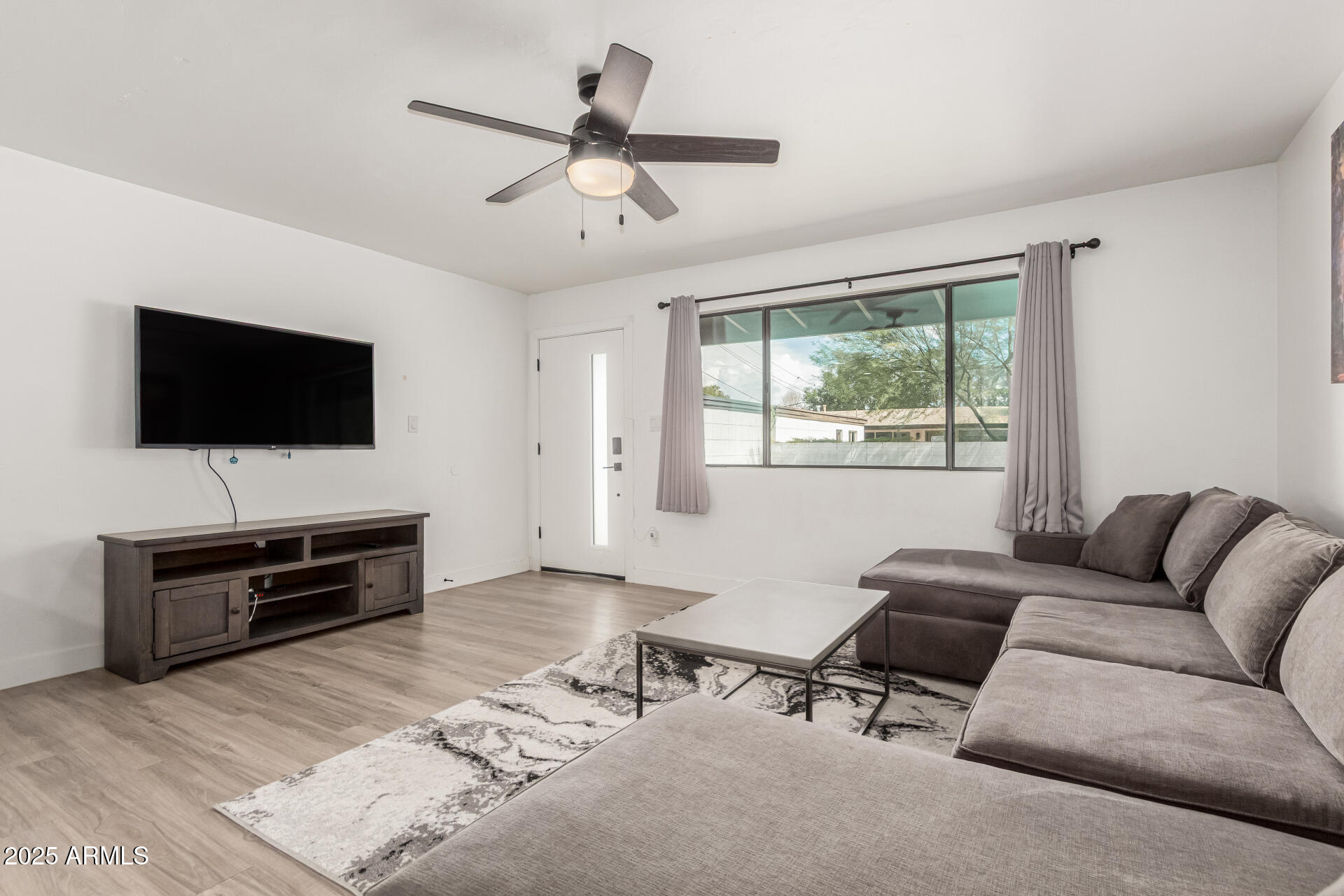 6628 East Avalon Drive, Unit 1 Scottsdale, AZ 85251 - Photo 6 of 29 a living room with furniture and a flat screen tv