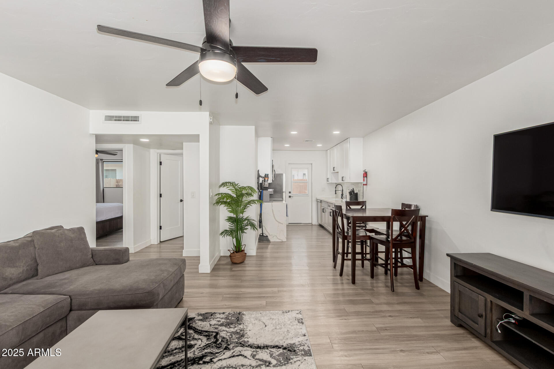 6628 East Avalon Drive, Unit 1 Scottsdale, AZ 85251 - Photo 7 of 29 a living room with furniture and a flat screen tv