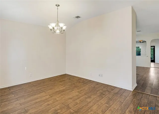 a view of a chandelier fan and wooden floor
