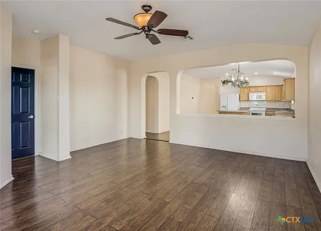 a view of a kitchen with wooden floor and a ceiling fan