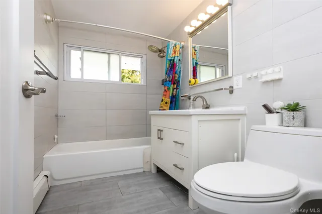 a bathroom with a sink a toilet a mirror and shower